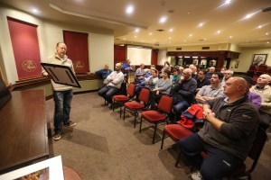 John Hall showing his work to members of the club